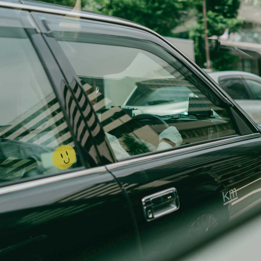 Transparent yellow smiley sticker on car window