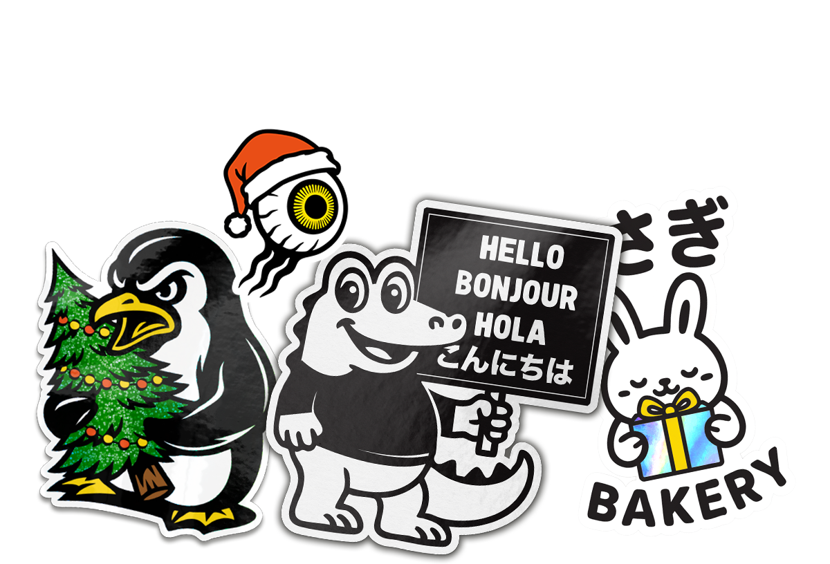 Collection of playful custom stickers featuring cartoon characters, including a penguin holding a Christmas tree, a smiling crocodile holding a multilingual ‘Hello’ sign, a bunny with a gift, a festive eyeball in a Santa hat, and bold ‘Custom Stickers’ designs, arranged together on a white background.